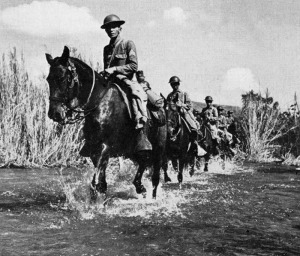 Philippine Scouts of the Machine Gun Troop of the 26th Cavalry Regiment (PS) ford a river just prior to the Japanese invasion. From the cover of the March/April, 1943 issue of "The Cavalry Journal".  (Courtesy Historum.com and Philippine Scouts Heritage Society)